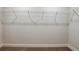 Empty walk-in closet features carpeted floor and metal shelving at 6218 Sw 95Th Pl, Ocala, FL 34476