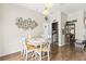 Cozy dining area features a round table, decorative wall art, and easy access to the laundry room at 2644 W 75Th Blvd, Bushnell, FL 33513