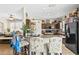 Open kitchen featuring a breakfast bar, dark appliances, and ample counter space, perfect for cooking at 2644 W 75Th Blvd, Bushnell, FL 33513