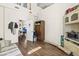 Bright living room with high ceilings, wood floors, and an open doorway to other parts of the home at 2644 W 75Th Blvd, Bushnell, FL 33513