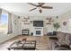 Bright living room with a fireplace, ceiling fan, and neutral decor for a welcoming atmosphere at 2644 W 75Th Blvd, Bushnell, FL 33513