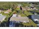 View of a cozy single-story home featuring a well-kept lawn, mature trees, and a convenient carport at 1019 Milner E Dr, Lakeland, FL 33810