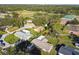 An aerial view captures a charming single-story home with a lush green lawn and mature, shady trees at 1019 Milner E Dr, Lakeland, FL 33810