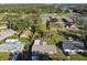 A lovely single-story home with a lush green lawn, surrounded by mature trees, captured from an aerial view at 1019 Milner E Dr, Lakeland, FL 33810