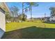 Large backyard with mature trees and lush green lawn at 1019 Milner E Dr, Lakeland, FL 33810