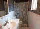 Neutral bathroom featuring a toilet, sink, and tub with a floral shower curtain at 1019 Milner E Dr, Lakeland, FL 33810