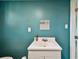 Bathroom featuring blue walls, white vanity, and square mirror at 1019 Milner E Dr, Lakeland, FL 33810