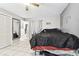 Bedroom with tile floors, fan, and large bed with adjacent wall decor at 1019 Milner E Dr, Lakeland, FL 33810