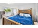 Cozy bedroom featuring hardwood floors, natural light, and a decorative wood headboard at 1019 Milner E Dr, Lakeland, FL 33810