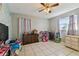 bedroom with a ceiling fan, tile floors, and window at 1019 Milner E Dr, Lakeland, FL 33810