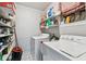 Functional laundry area with washer, dryer and storage shelving at 1019 Milner E Dr, Lakeland, FL 33810