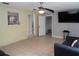 Open-plan living room with tile floors and a ceiling fan, connected to other rooms at 1019 Milner E Dr, Lakeland, FL 33810