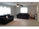 Living room with tile floors, ceiling fan, and plenty of natural light at 1019 Milner E Dr, Lakeland, FL 33810