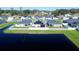 Aerial view of community featuring solar panels, lake, green lawn, and neighborhood homes at 6855 Mossy Oak Ln, Lakeland, FL 33810