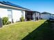 Spacious backyard with well-maintained lawn and covered patio for outdoor relaxation at 6855 Mossy Oak Ln, Lakeland, FL 33810