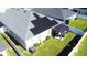 Aerial view of backyard featuring solar panels, patio, fence, and well-maintained green lawn at 6855 Mossy Oak Ln, Lakeland, FL 33810