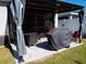 Outdoor backyard patio area, includes a barbeque and table for entertaining at 6855 Mossy Oak Ln, Lakeland, FL 33810