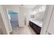 Bathroom showcasing a double sink vanity with modern light fixtures and wood-look floors at 6855 Mossy Oak Ln, Lakeland, FL 33810