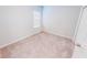 Bright bedroom featuring a neutral color palette, plush carpeting, and a window allowing for natural light at 6855 Mossy Oak Ln, Lakeland, FL 33810
