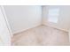 Neutral bedroom featuring a plush carpet, window allowing natural light, and closet for storage at 6855 Mossy Oak Ln, Lakeland, FL 33810