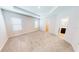 Spacious main bedroom with tray ceiling, carpet, and walk-in closet at 6855 Mossy Oak Ln, Lakeland, FL 33810