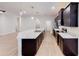 Modern kitchen features stainless steel appliances, dark wood cabinets, and large island with white countertop at 6855 Mossy Oak Ln, Lakeland, FL 33810