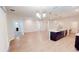 Bright open-concept living space with hardwood floors, neutral walls, and a modern kitchen island at 6855 Mossy Oak Ln, Lakeland, FL 33810
