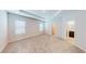 Large primary bedroom with tray ceiling, plush carpet, and ensuite bathroom with a walk-in closet at 6855 Mossy Oak Ln, Lakeland, FL 33810