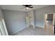 Bright bedroom with grey walls, wood-look floors, and a spacious closet at 13898 Sw 32Nd Ter, Ocala, FL 34473