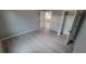 Simple bedroom featuring light grey walls and wood-look vinyl flooring at 13898 Sw 32Nd Ter, Ocala, FL 34473