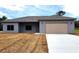 Newly constructed home with gray siding and a two-car garage at 13898 Sw 32Nd Ter, Ocala, FL 34473