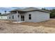 Gray house exterior with covered patio and a large backyard at 13898 Sw 32Nd Ter, Ocala, FL 34473