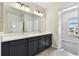 Bathroom features dual sinks, vanity, and a large mirror at 3007 Mirage Pl, St Cloud, FL 34771