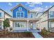 Charming two-story home featuring a welcoming front porch, blue accents and well-maintained landscaping at 3007 Mirage Pl, Saint Cloud, FL 34771