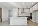 Well-lit kitchen with a spacious island, stainless steel appliances, and sleek cabinetry at 3007 Mirage Pl, St Cloud, FL 34771