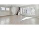 Expansive living room with large windows, tile floors, and open access to the staircase at 3007 Mirage Pl, St Cloud, FL 34771