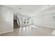 Open-concept living space with staircase, big windows, and ceramic tile flooring at 3007 Mirage Pl, St Cloud, FL 34771