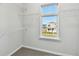 Bedroom walk-in closet with wire racks and a window to outside at 3007 Mirage Pl, St Cloud, FL 34771