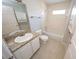 Well-lit bathroom with a shower and bathtub combo, vanity sink, and neutral-toned tiling at 2819 Ne 25Th St, Ocala, FL 34470