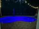 Relaxing backyard pool area featuring ambient string lights and comfortable seating, ideal for evening gatherings at 2819 Ne 25Th St, Ocala, FL 34470