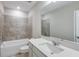 Well lit bathroom with a shower and tub combination with a stone tile surround at 5429 Sw 85Th Avenue Rd, Ocala, FL 34481