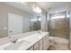 Modern bathroom with double vanity, quartz countertops, tiled shower, and ample lighting at 5429 Sw 85Th Avenue Rd, Ocala, FL 34481