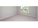 Bright bedroom with carpeted floor and large window at 5429 Sw 85Th Avenue Rd, Ocala, FL 34481