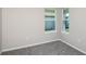 Cozy bedroom featuring soft gray carpet and two windows allowing plenty of natural light at 5429 Sw 85Th Avenue Rd, Ocala, FL 34481