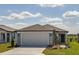 Charming single-Gathering home featuring a gray exterior, well-maintained landscaping, and a two-car garage at 5429 Sw 85Th Avenue Rd, Ocala, FL 34481