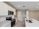 Well-lit kitchen featuring white cabinets, stainless steel appliances, and a kitchen island with a sink at 5429 Sw 85Th Avenue Rd, Ocala, FL 34481