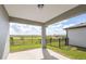 Outdoor patio with a metal fence overlooking a vast field in a rural area at 5429 Sw 85Th Avenue Rd, Ocala, FL 34481