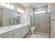 Bright bathroom featuring double vanity with white countertops and large shower with glass door and built-in bench at 5813 Sw 87Th Court Rd, Ocala, FL 34481