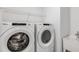 Modern laundry room with white, front-load washer and dryer, and utility sink at 8319 Sw 54Th Loop, Ocala, FL 34481