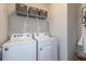 Bright laundry room with washer and dryer, and shelving for storage at 8319 Sw 54Th Loop, Ocala, FL 34481